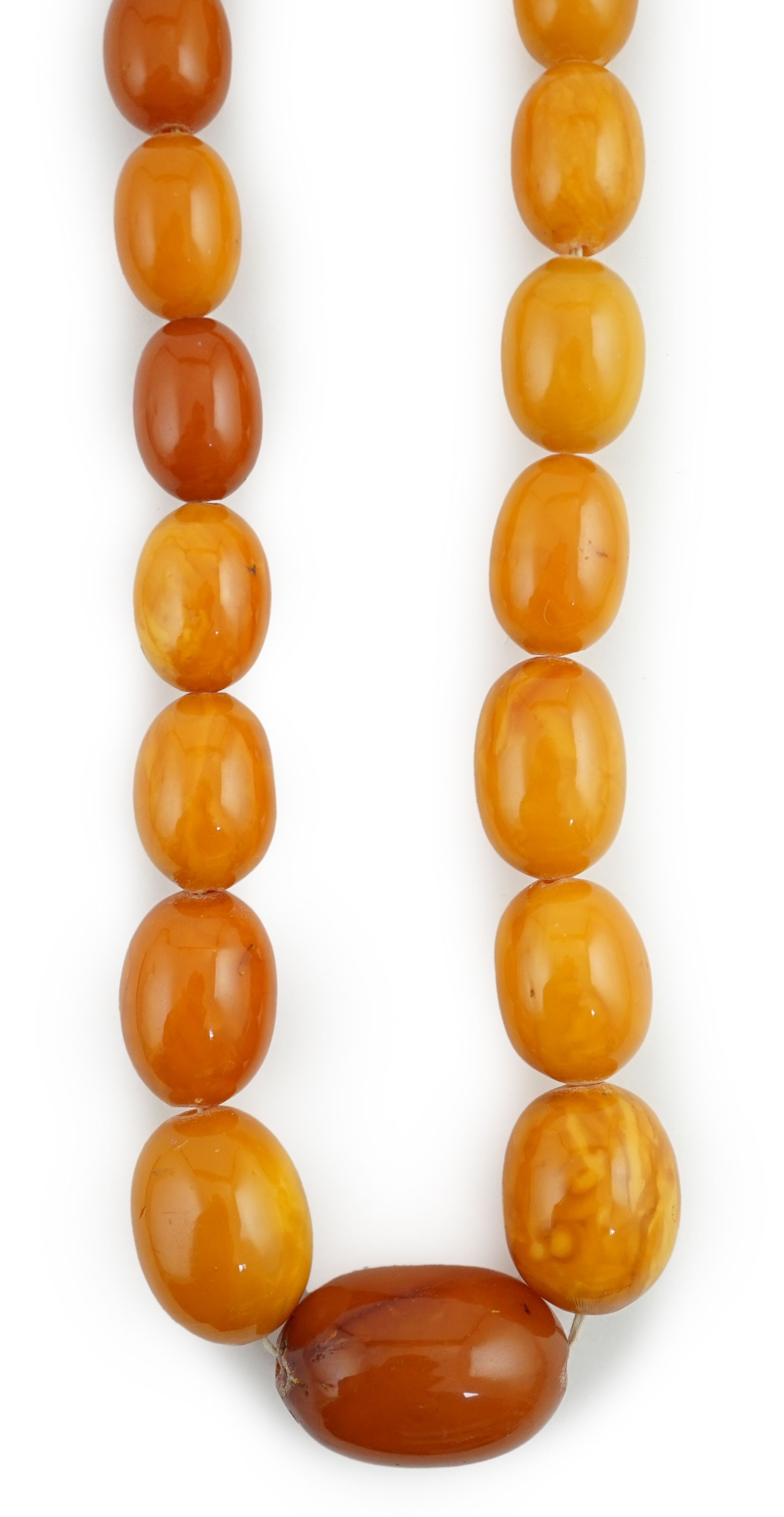 A single strand graduated oval amber bead necklace